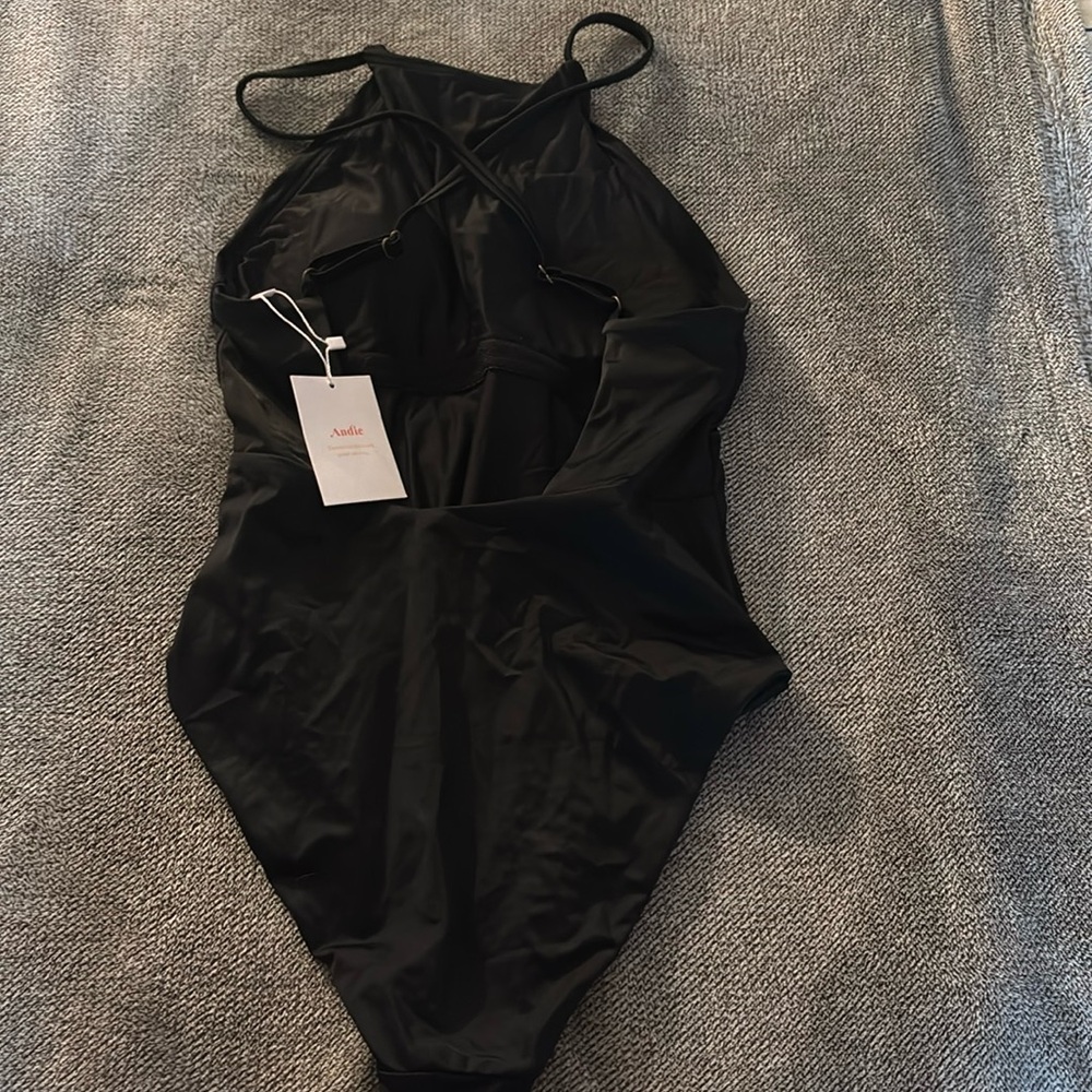 Andie the asbury one piece. Has a high neck and crosses on the back.